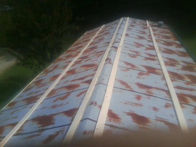 Rusted metal roof panels with new wood purlins before replacement — Storm Damage Roof Repair in Seanor by Roofing Brothers