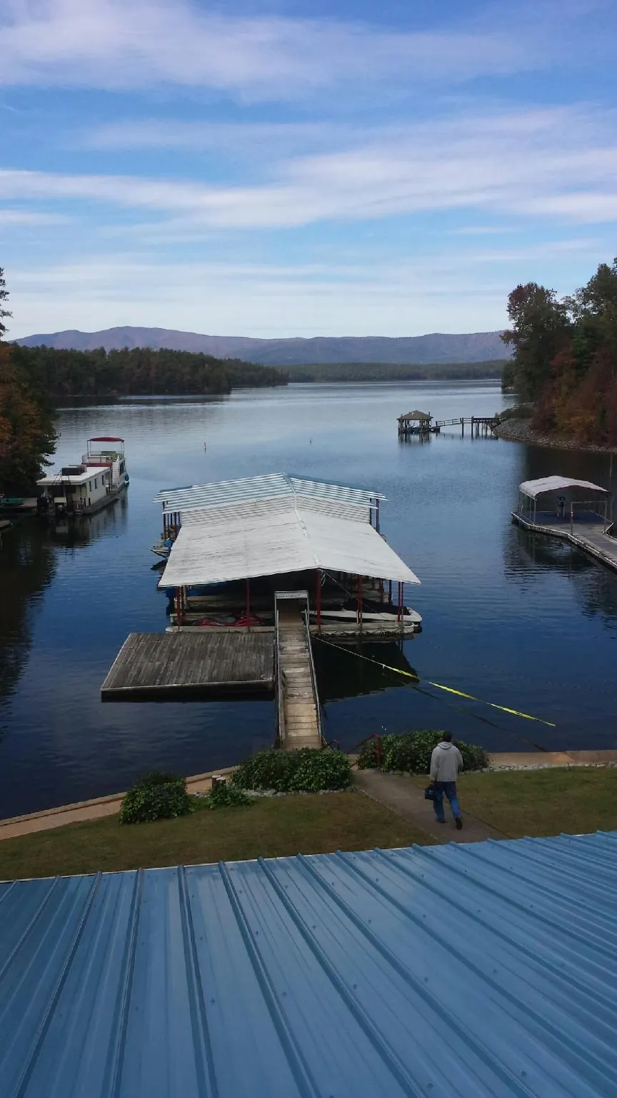 View across a lake from a newly installed blue metal roof in Seanor