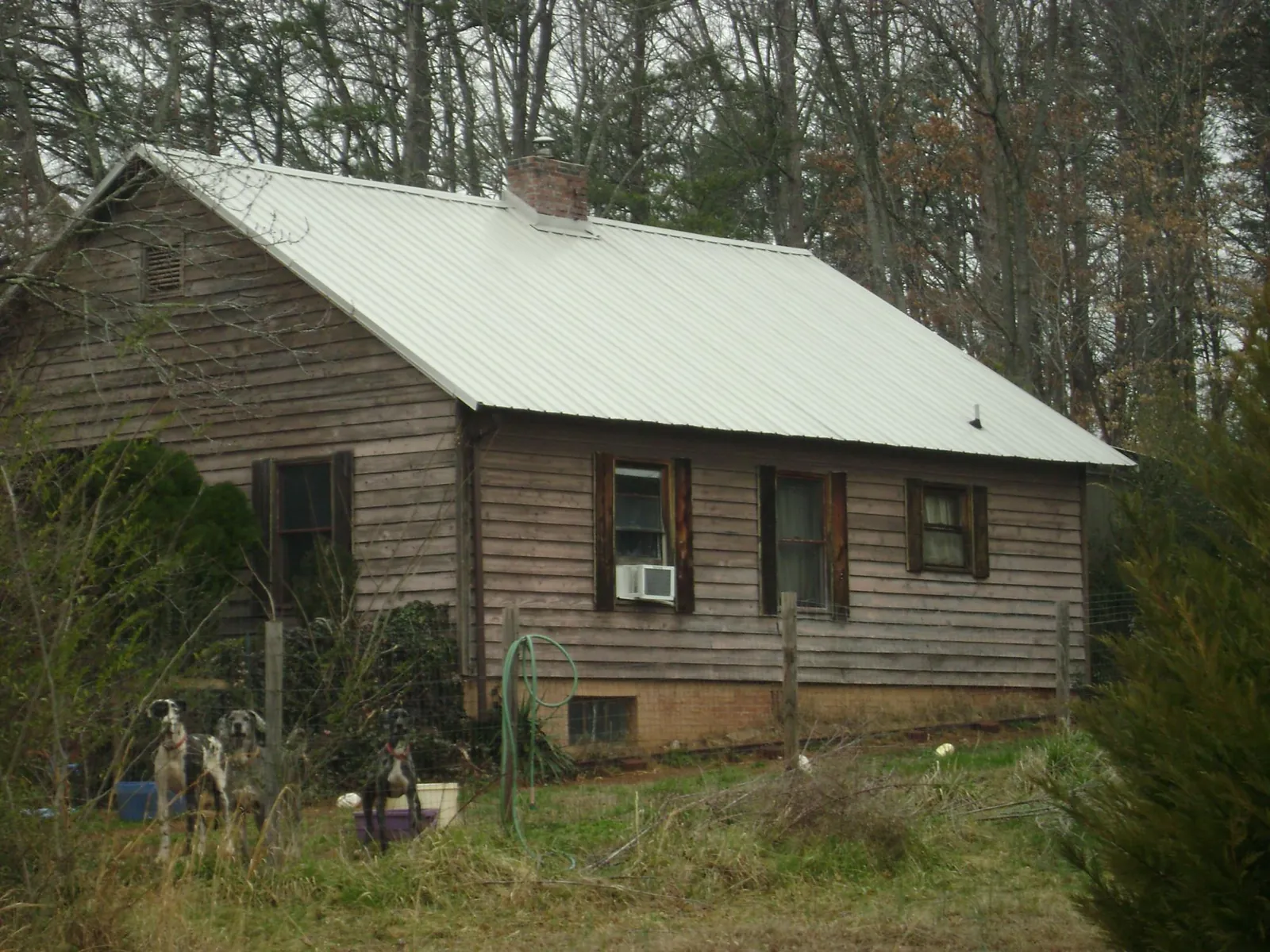 White metal roof on an old wood sided farmhouse, from a Metal Roof Installation job in Seanor